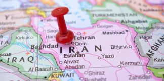 Red pushpin marking Iran on a map