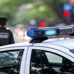 Police car and officer on a city street