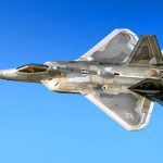 Fighter jet in flight against a clear blue sky