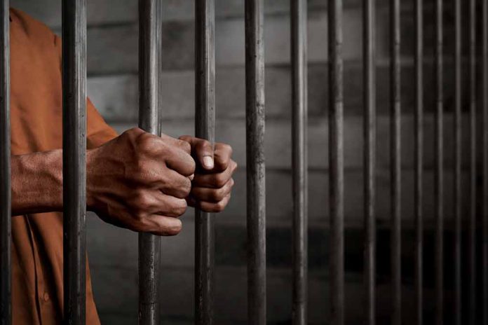 772489252 featured image Hands gripping prison cell bars tightly