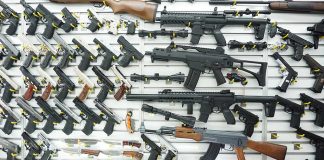 Wall display of various firearms in a store