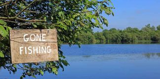 Sign saying Gone Fishing by a lake