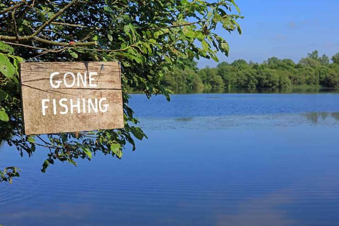 Sign saying Gone Fishing by a lake