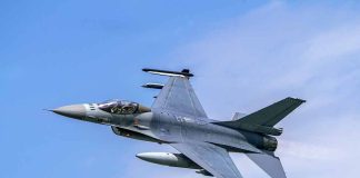 Jet fighter flying through clear blue sky