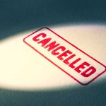 Red Cancelled stamp under a spotlight