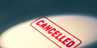 Red Cancelled stamp under a spotlight