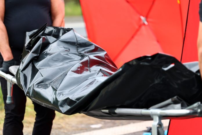 2458740387 featured image Person carrying body bag on stretcher outdoors