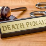 Gavel handcuffs and Death Penalty sign on desk