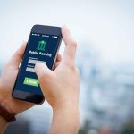 Person using mobile banking app on smartphone
