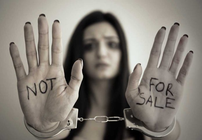 631031339 featured image Handcuffed woman shows NOT FOR SALE on her palms