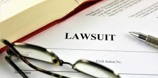 Lawsuit document with glasses pen and book