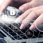 Hands typing with cybersecurity icons overlay