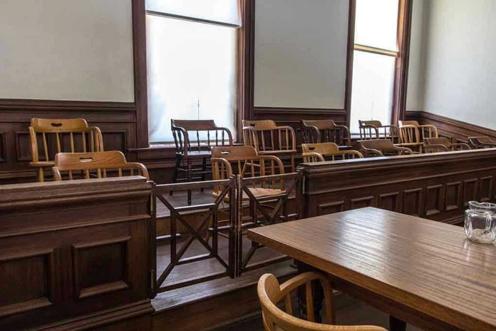 1403556146 Empty jury box and table in courtroom