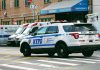 Police car and ambulances outside emergency room entrance