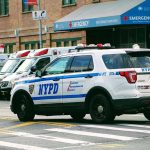 Police car and ambulances outside emergency room entrance