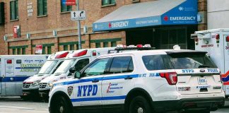 Police car and ambulances outside emergency room entrance