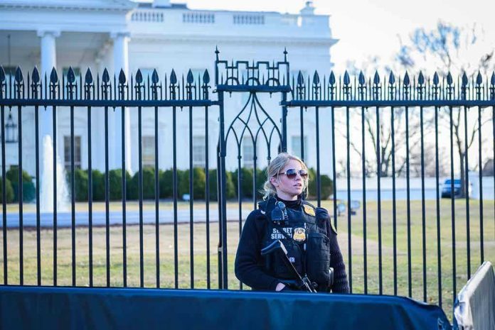 1435108799 Secret Service agent stands guard outside the White House