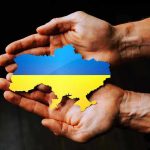 Hands holding Ukraine map with flag design