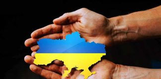 Hands holding Ukraine map with flag design