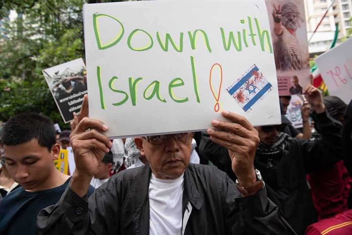 2378341151 featured image Person holding Down with Israel sign at protest