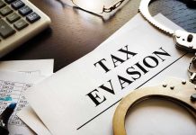 Tax evasion document with handcuffs calculator and papers