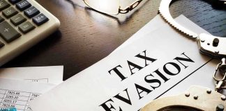Tax evasion document with handcuffs calculator and papers