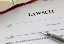 Lawsuit paperwork with pen and open book