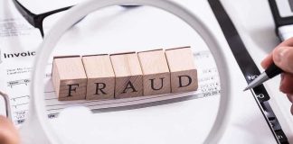 Fraud blocks under magnifying glass on invoices