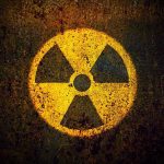 Radioactive Shrimp Scare—Walmart Recall Sparks Panic Yellow radiation warning symbol on rusty metal surface.