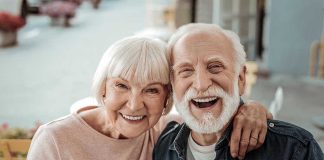Elderly couple smiling together outdoors