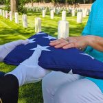 Flag folded and handed over at gravesite ceremony.