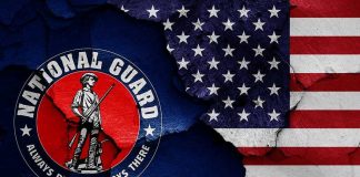 National Guard logo over a distressed American flag
