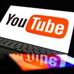 YouTube logo on a laptop and smartphone screen