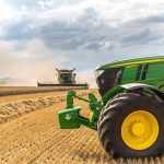 A green tractor in a wheat field