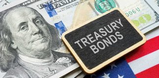 Close-up of U.S. currency with a sign reading 'Treasury Bonds' on an American flag background