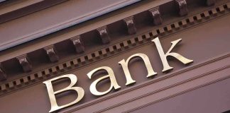 Close-up of a bank sign with gold lettering