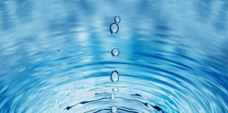 Water droplets creating ripples on a surface