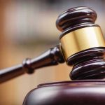 Judges gavel striking a sound block.