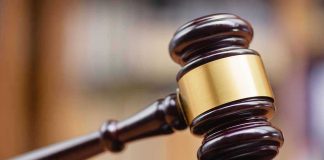 Judges gavel striking a sound block.