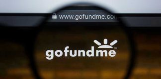 Magnifying glass over GoFundMe website logo.
