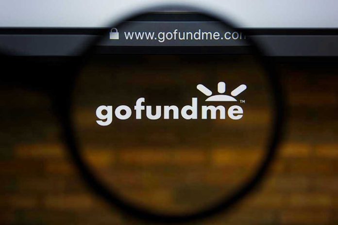 1460614706 Magnifying glass over GoFundMe website logo.