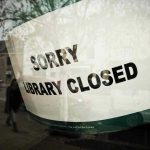 Sorry, library closed sign on window.