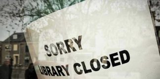 Sorry, library closed sign on window.