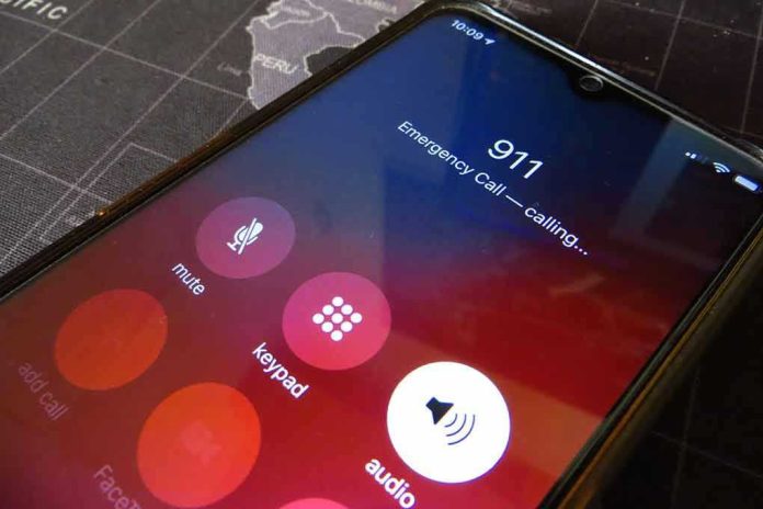 Phone screen showing 911 emergency call in progress.