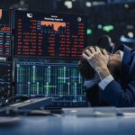 Trader stressed out by multiple declining stock charts.