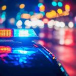 Cobb County Horror: Infant Killed in Hotel Shooting Police car with flashing lights at night.