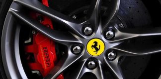 Close-up of a Ferrari wheel showcasing the brake caliper and logo