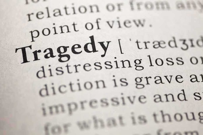 Close-up of the word Tragedy in a dictionary with its definition