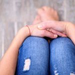 Another Teacher Busted — Undercover Raid Exposes Dark Secrets Person sitting with folded hands on knees.