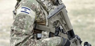 Soldier in camouflage gear with Israeli flag patch